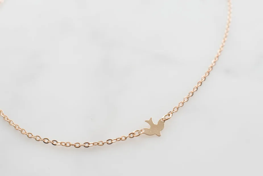Original gold bird pendant necklace packshot on a plain background, as uploaded to Shopify.